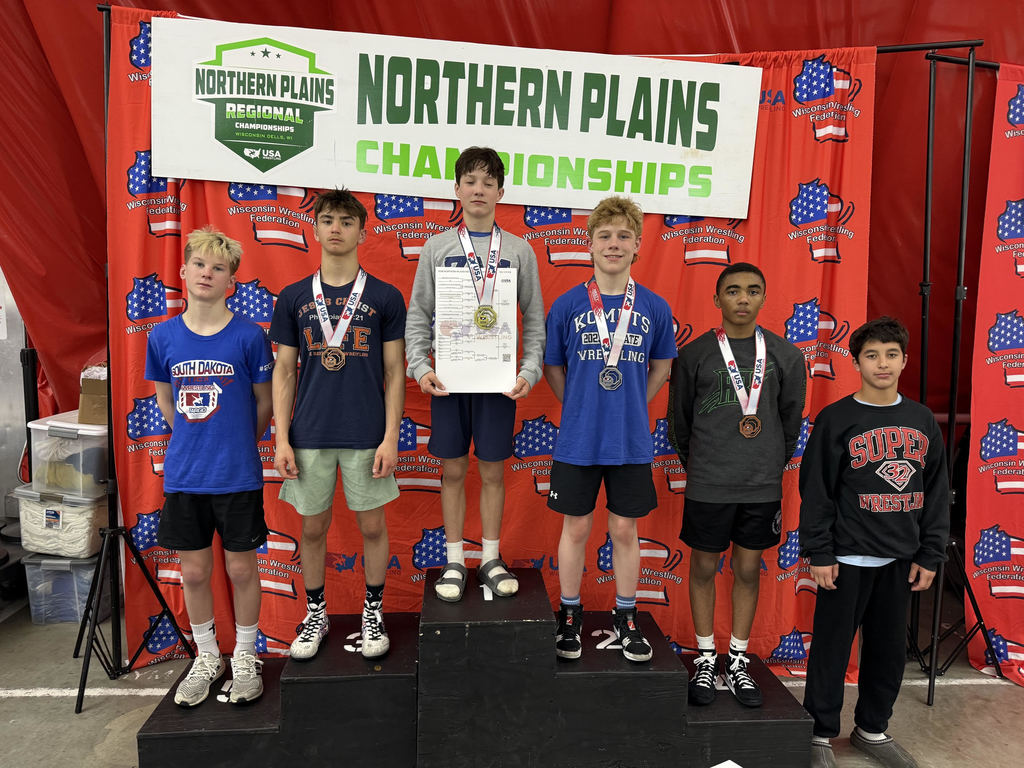 wrestlers standing on the podium