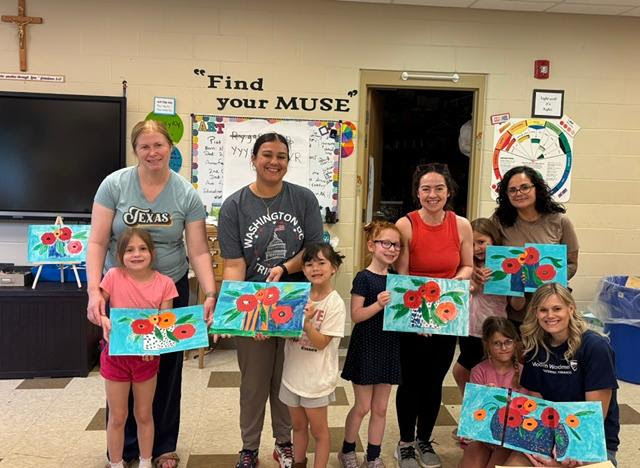 moms and daughters posing with paintings