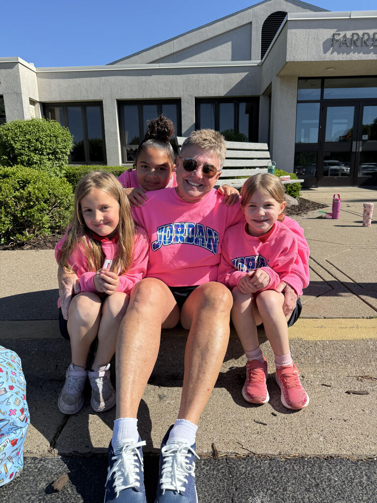 4 people all dressed in matching neon pink crewnecks