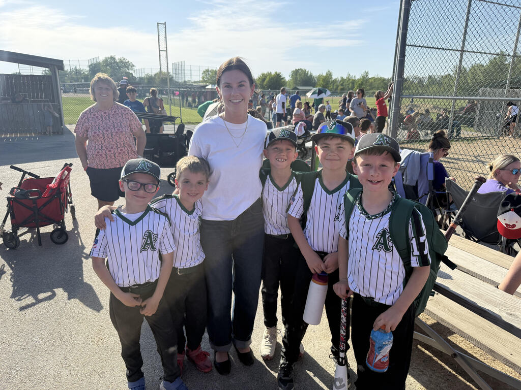 baseball players posing with their teacher