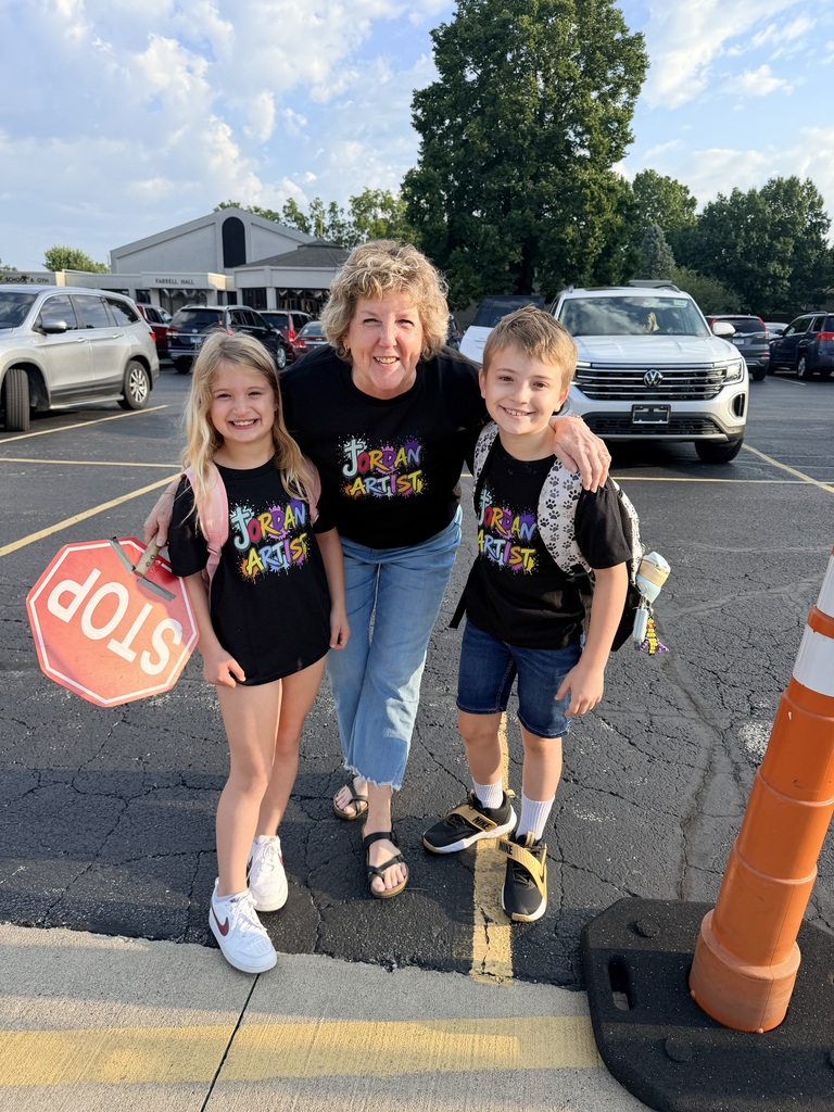 three people wearing the same tshirt posing with a stop sign