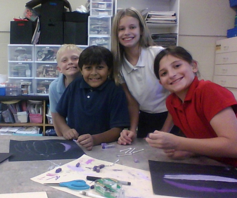 students posing in art classroom
