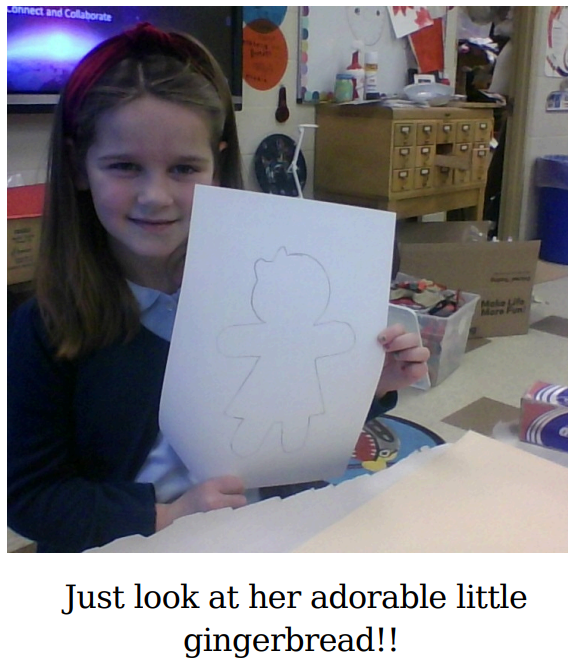 student showing outline of gingerbread girl on white paper