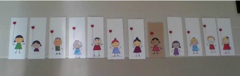 photo of drawings featuring children holding heart balloons