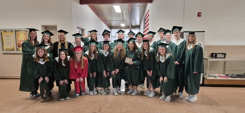 graduating students posing in their caps and gowns