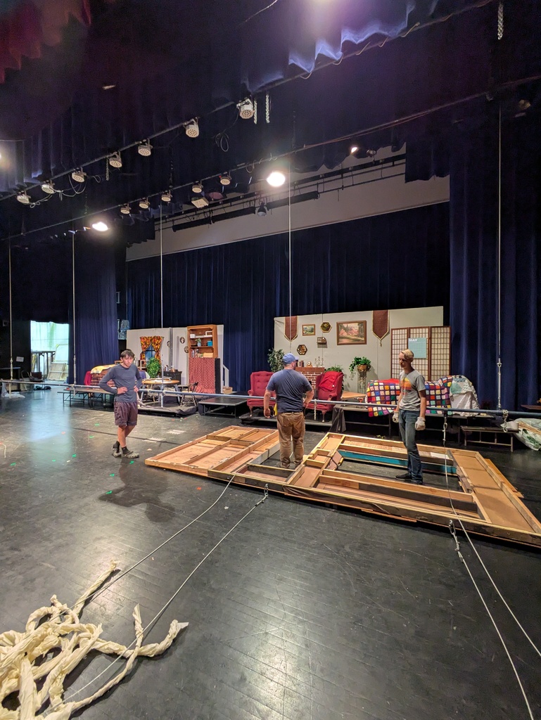 Men standing around housefront