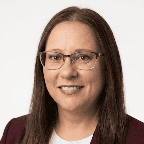 Photo of Pamela Dean, a woman with long brown hair and glasses.