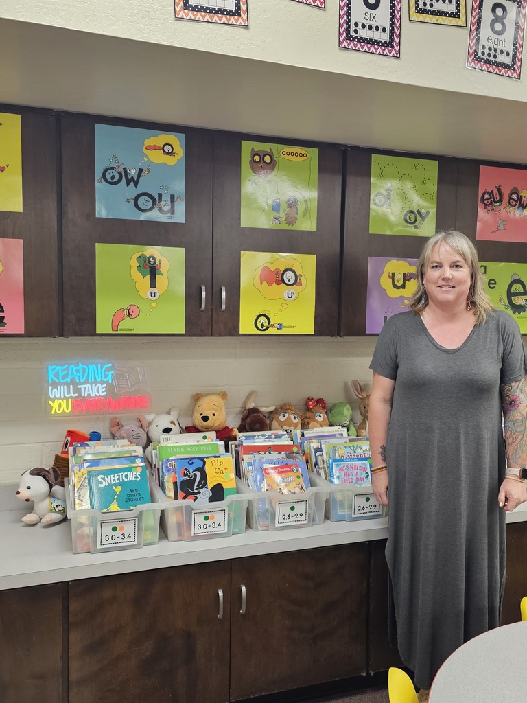 Mrs. Hunt in front of her phonics wall.