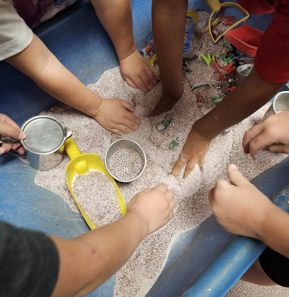 Hands in glitter sand