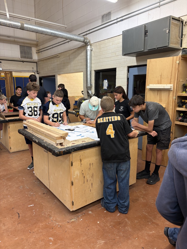Students measure different boards to the closest 16th of on inch.