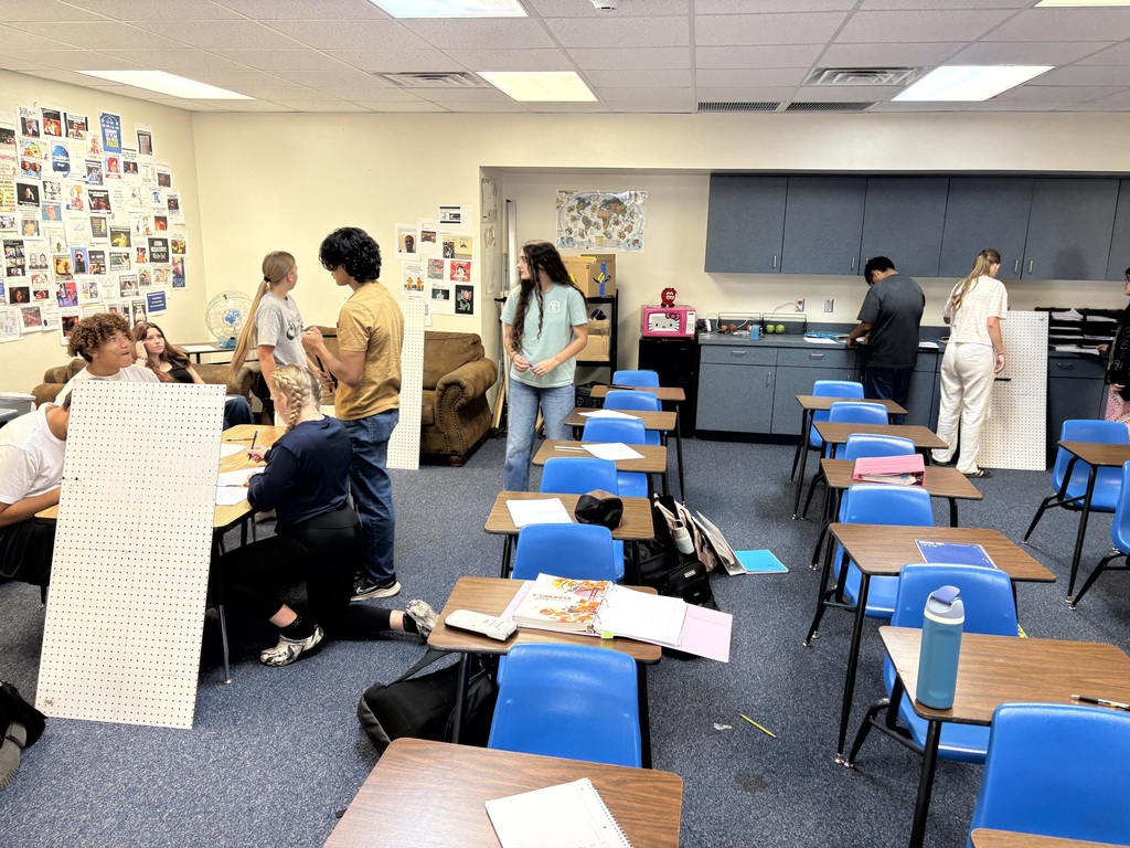 Algebra 2 students building marble tracks from peg boards