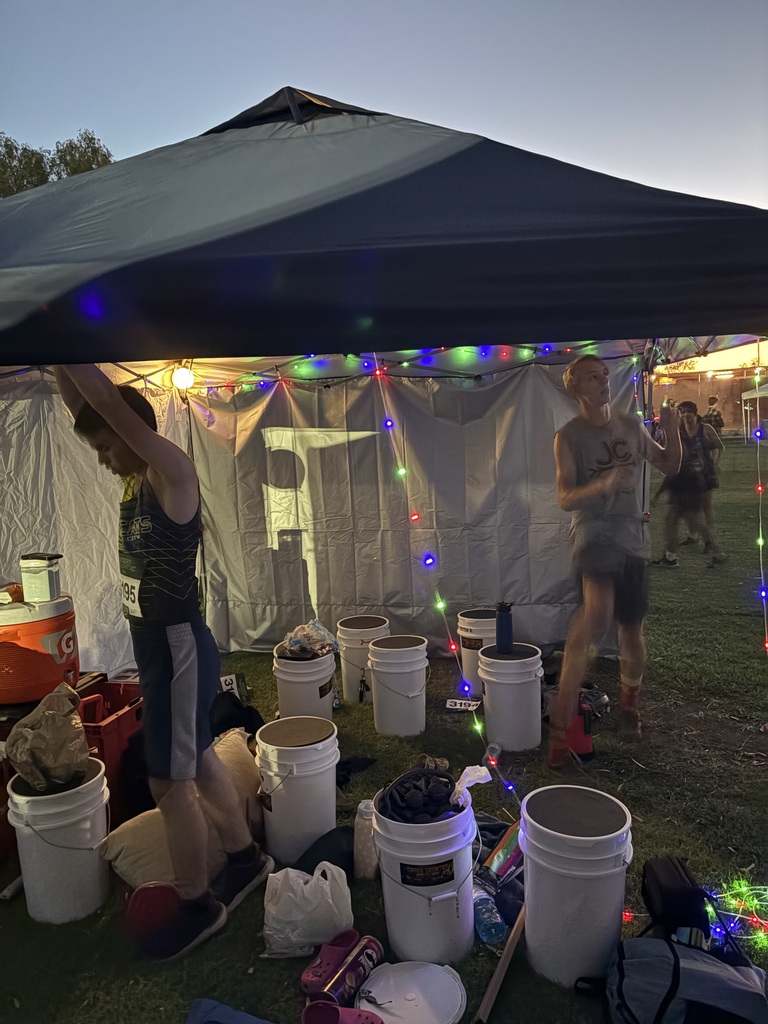 Cross country team enjoying desert Twilight race by stringing lights that previous coah Gayla Smith gifted to our students.