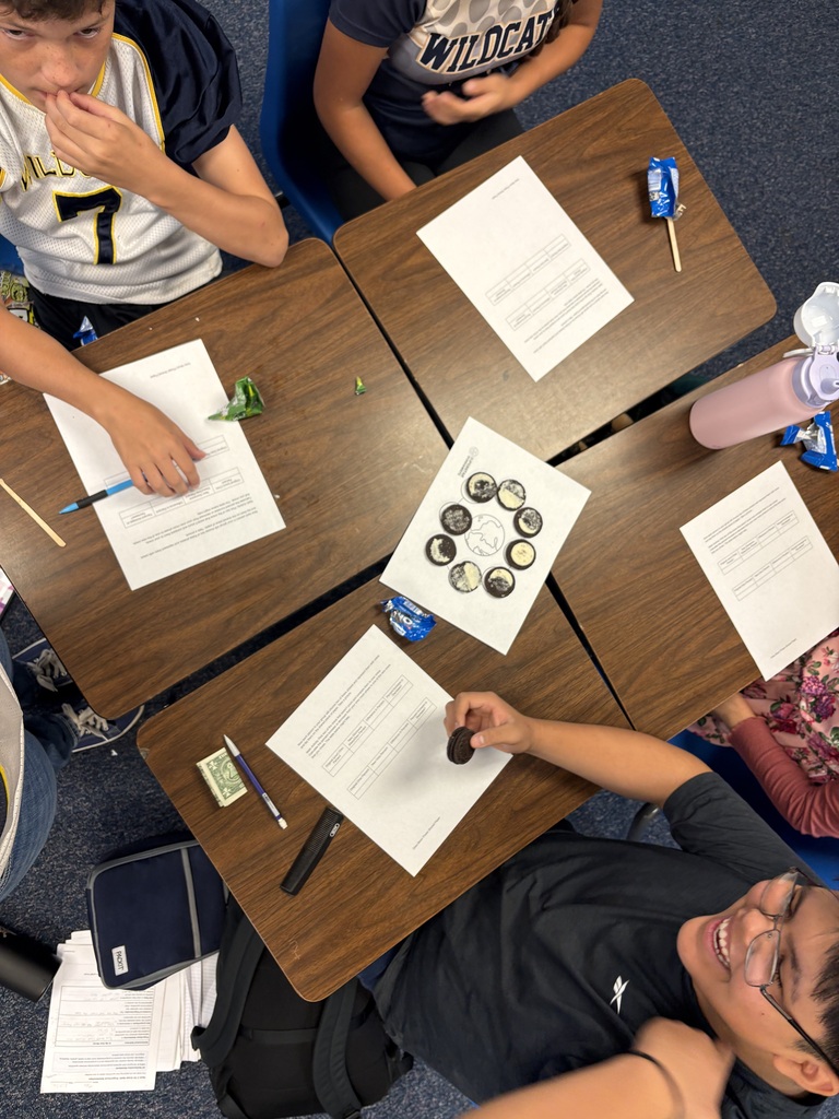 Students modeling percent increase and decrease by studying moon phases with oreos as the medium.