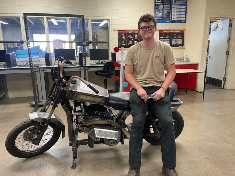 Rohnen Barney displays his custom motorcycle-inspired bike, modeled after a 1950 Honda Rebel and built with several modified and handcrafted components.