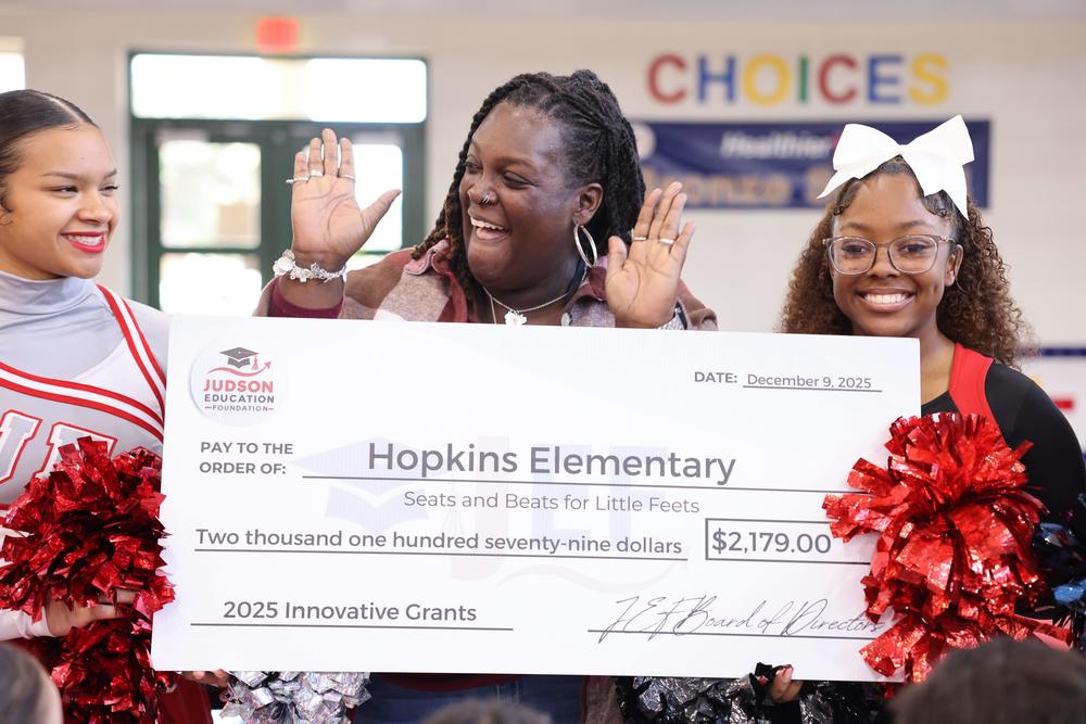Woman celebrating with a ceremonial check