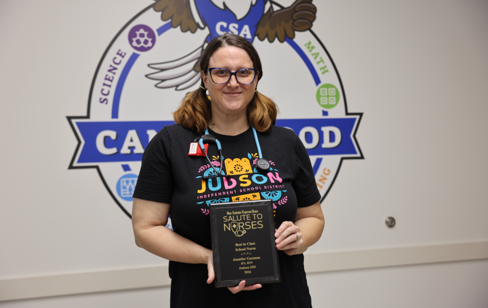 Woman with stethoscope holding an award. 