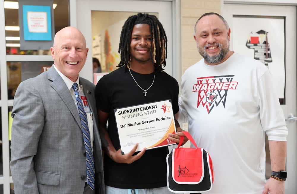 Two men with student between them holding an award certificate.