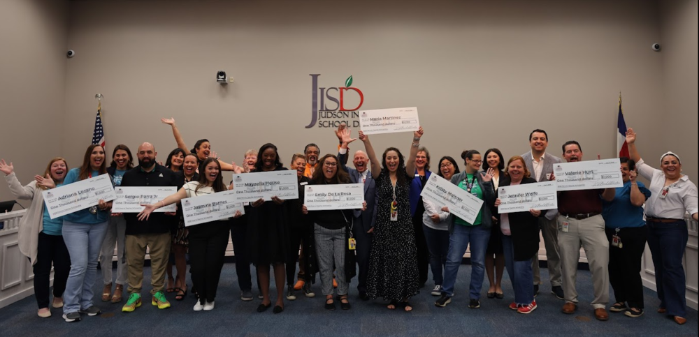 Group of people holding presentation checks.