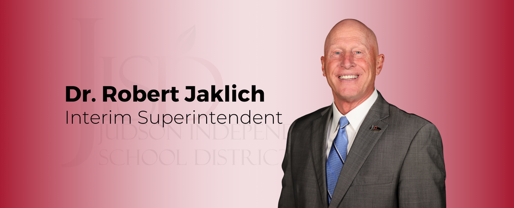 Dr. Robert Jaklich Interim Superintendent in a gray suit and blue tie