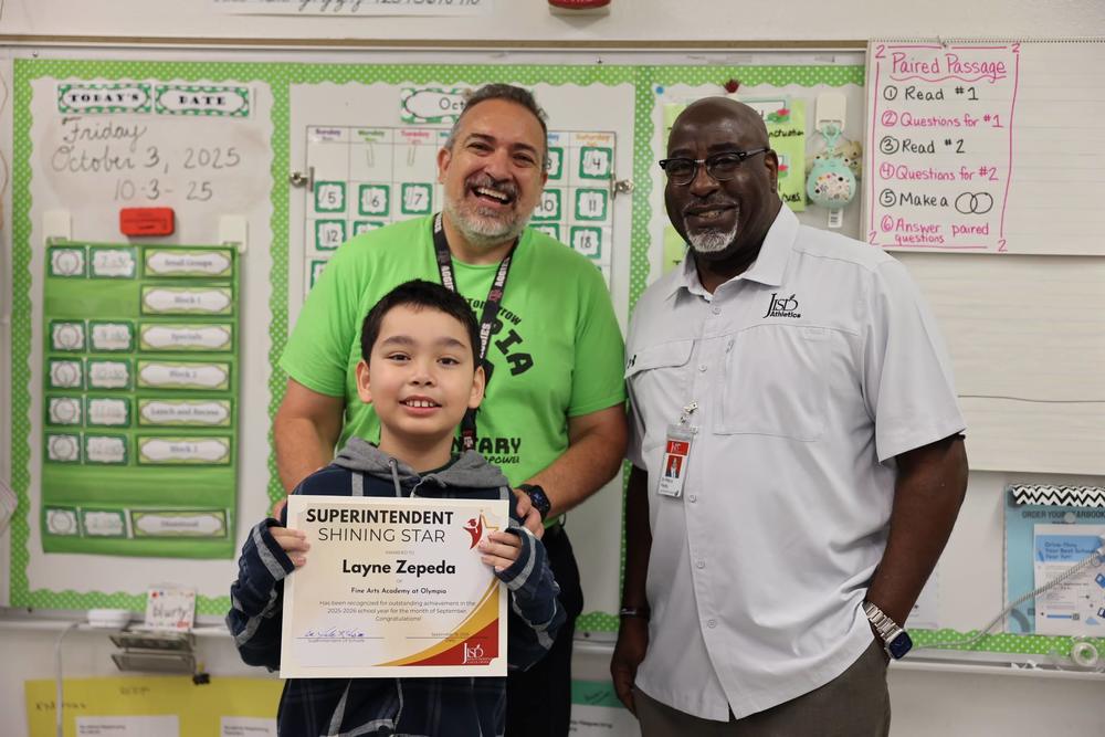 Boy with Principal and Superintendent