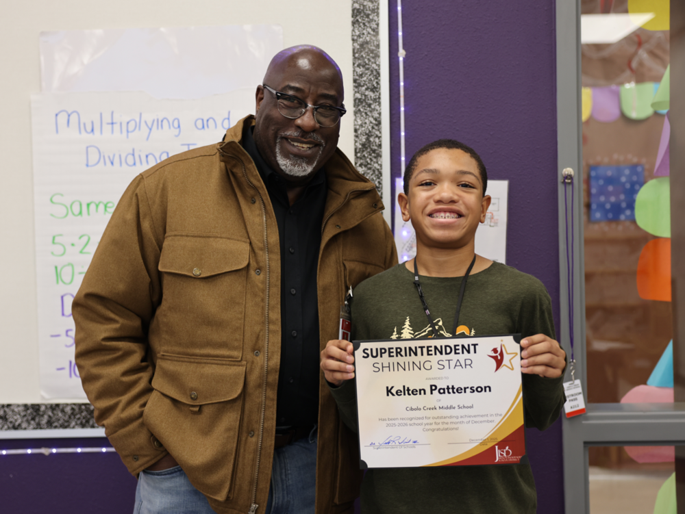 Man with student holding a certificate