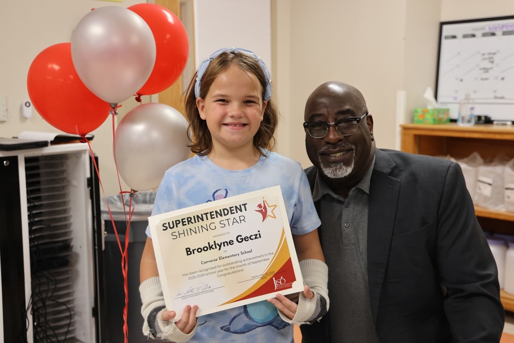 Student holding a certificate with Superintendent