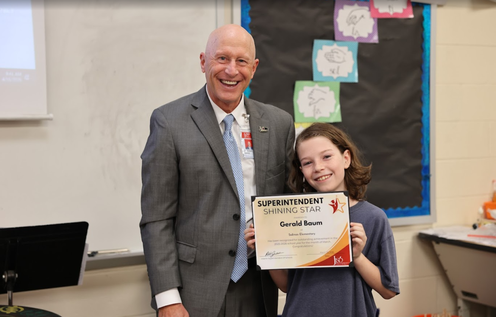 Man with student holding an award.