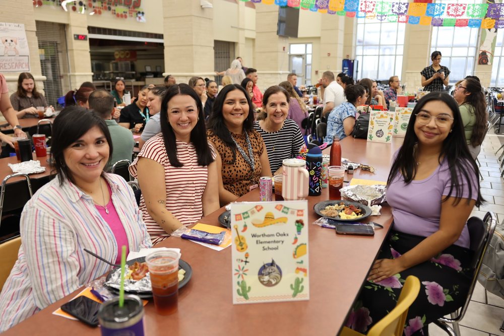 Ladies sitting around a table smiling