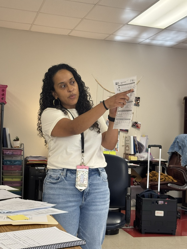 teacher pointing at paper