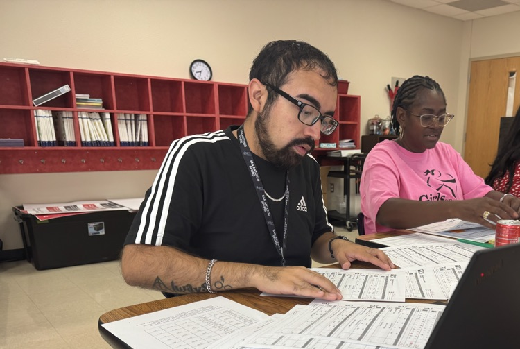 teacher looking at data