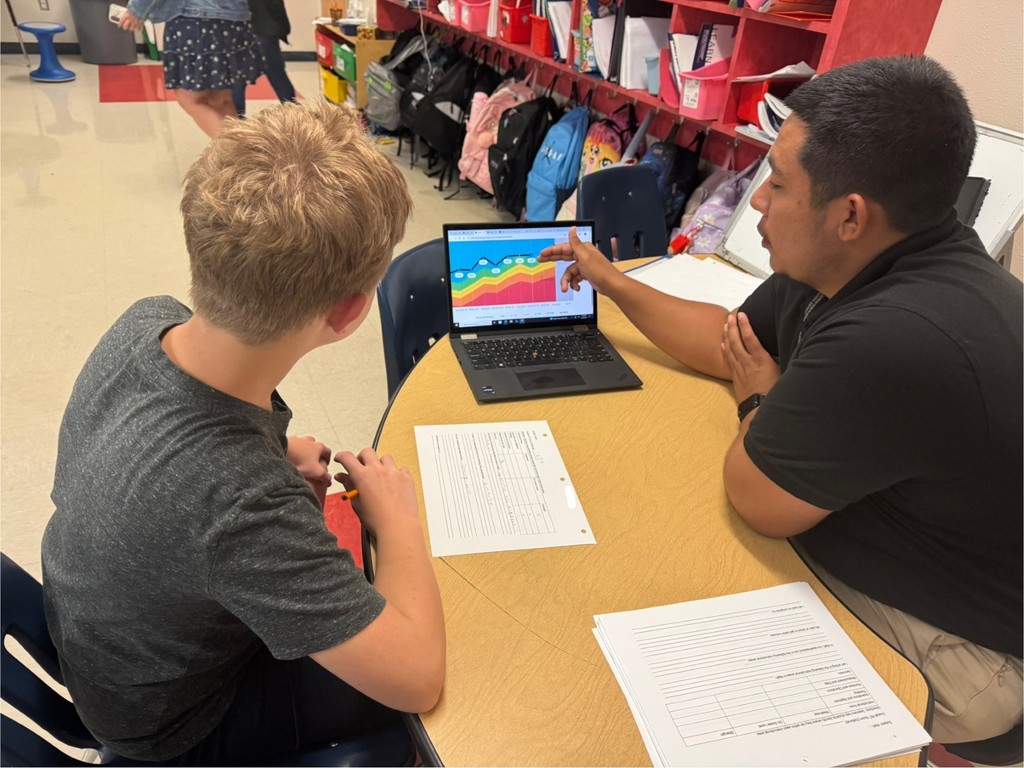 teacher working with a student