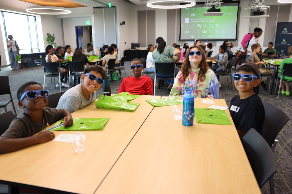 Group of Students with sun glasses on sitting at a table 