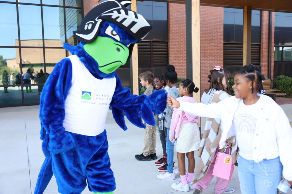 Student and mascot smiling 