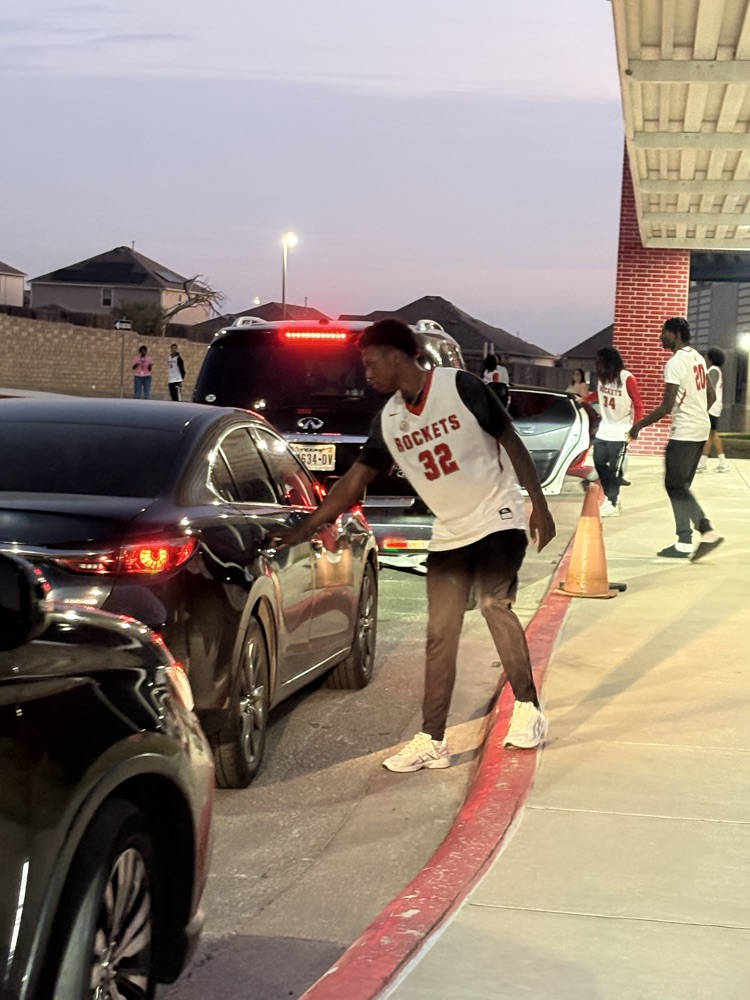 basketball player helping at car line