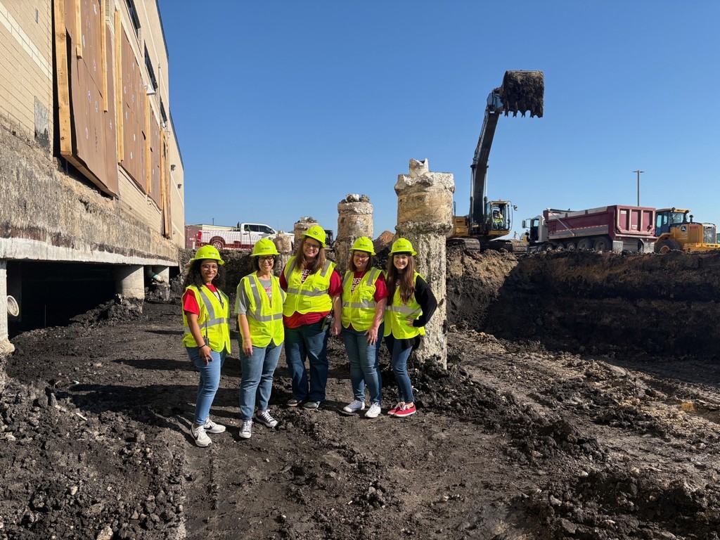 leadership team in front of the construction