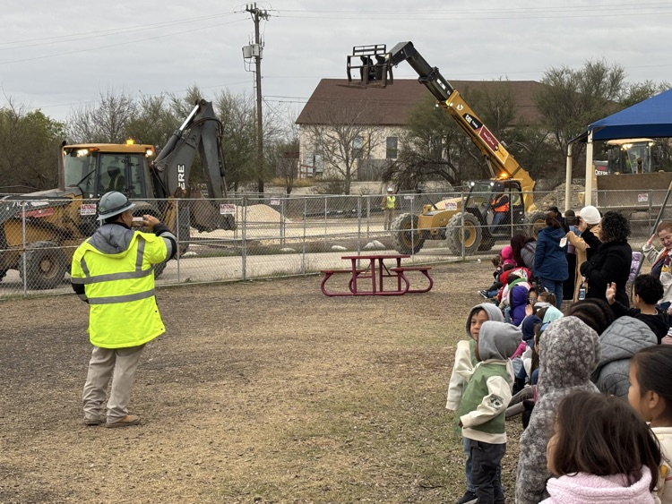kids looking at construction vehicles