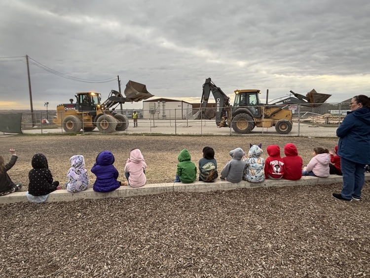 kids looking at construction vehicles