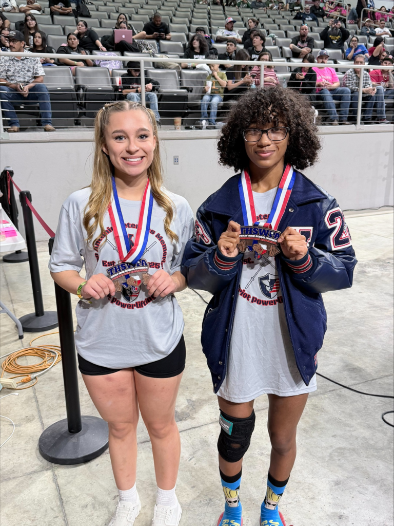 Jeruzalem and Ailani posing with their medals