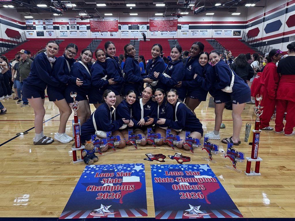 Dance team posing with their banners and trophies