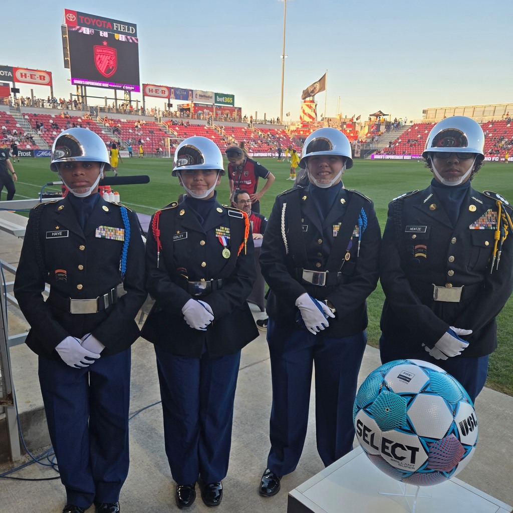 JROTC all-female colorguard poses with a SELECT branded soccer ball and the Toyota Field behind them