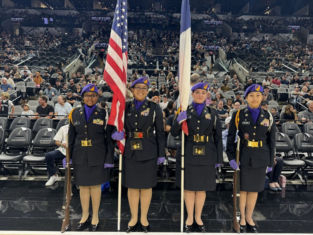 All-female JROTC colorguard poses inside the Frost Bank arena before the Spurs game