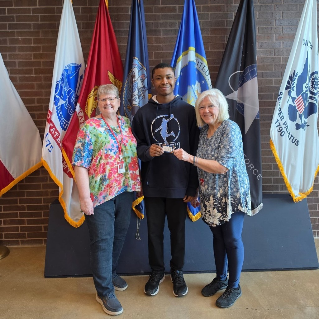 School board members Kenoyer and Stanford posing with student Anthony Ohaegbu in the VMHS foyer