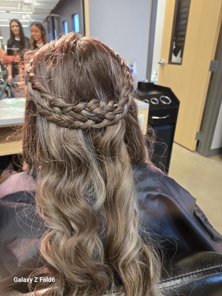 Student photo of braided prom hair with curls styled by cosmetology students at VMHS