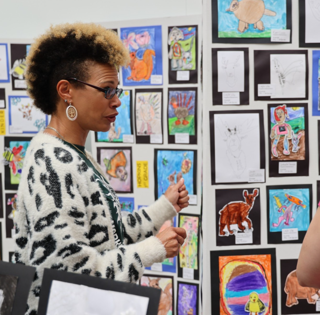 Teacher in front of art