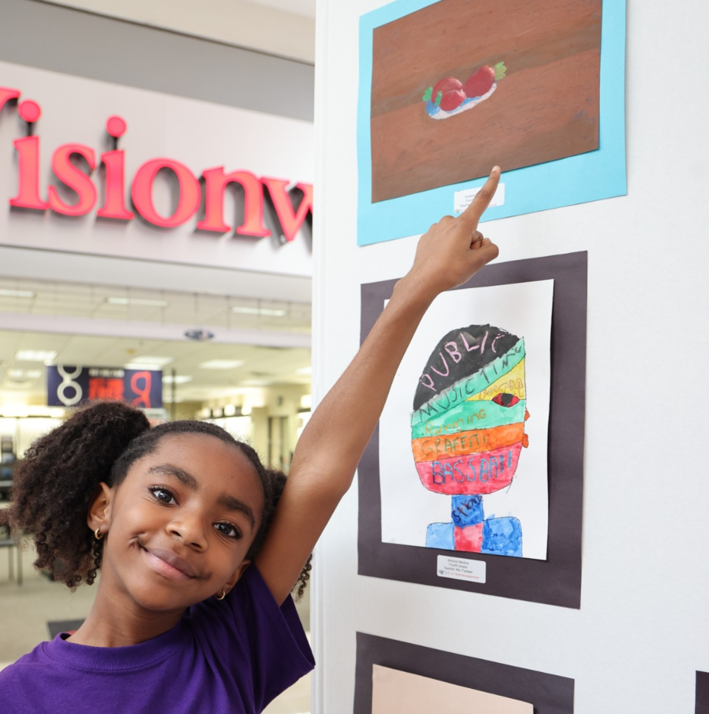 Student pointing at art
