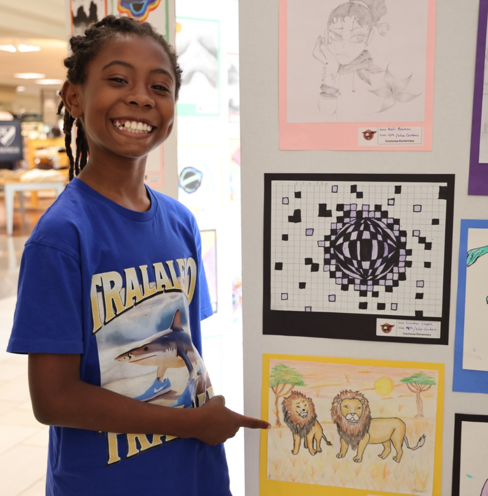 Student pointing at art