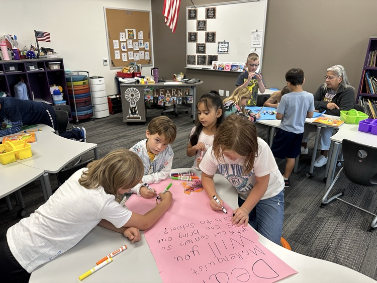 Students making posters for persuasive writing.