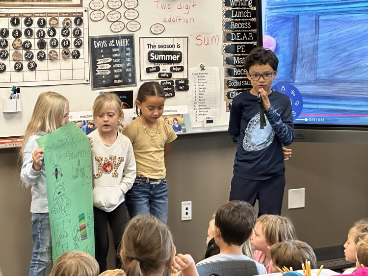 Presenting their posters.