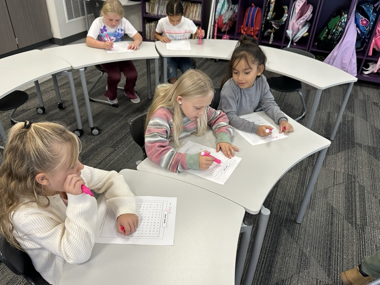 Working with partners to find their spelling words.