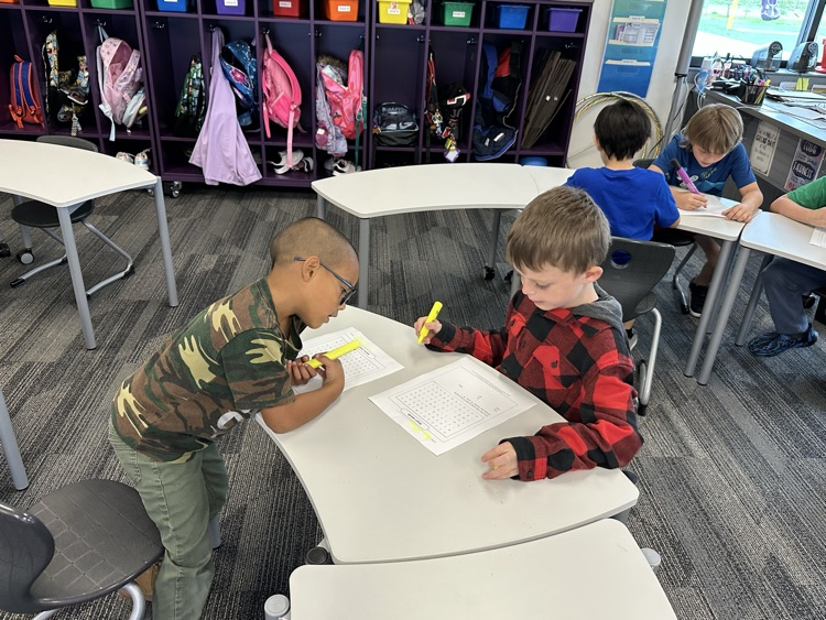 Working with partners to find their spelling words.